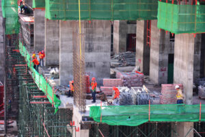 Asian labor people and thai labour workers use machine and heavy machinery working builder new building tower at construction site high-rise building on scaffold at capital city in Bangkok, Thailand