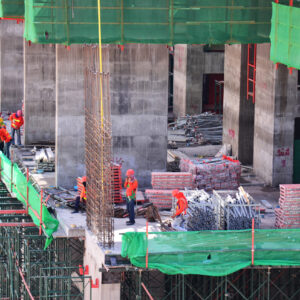 Asian labor people and thai labour workers use machine and heavy machinery working builder new building tower at construction site high-rise building on scaffold at capital city in Bangkok, Thailand